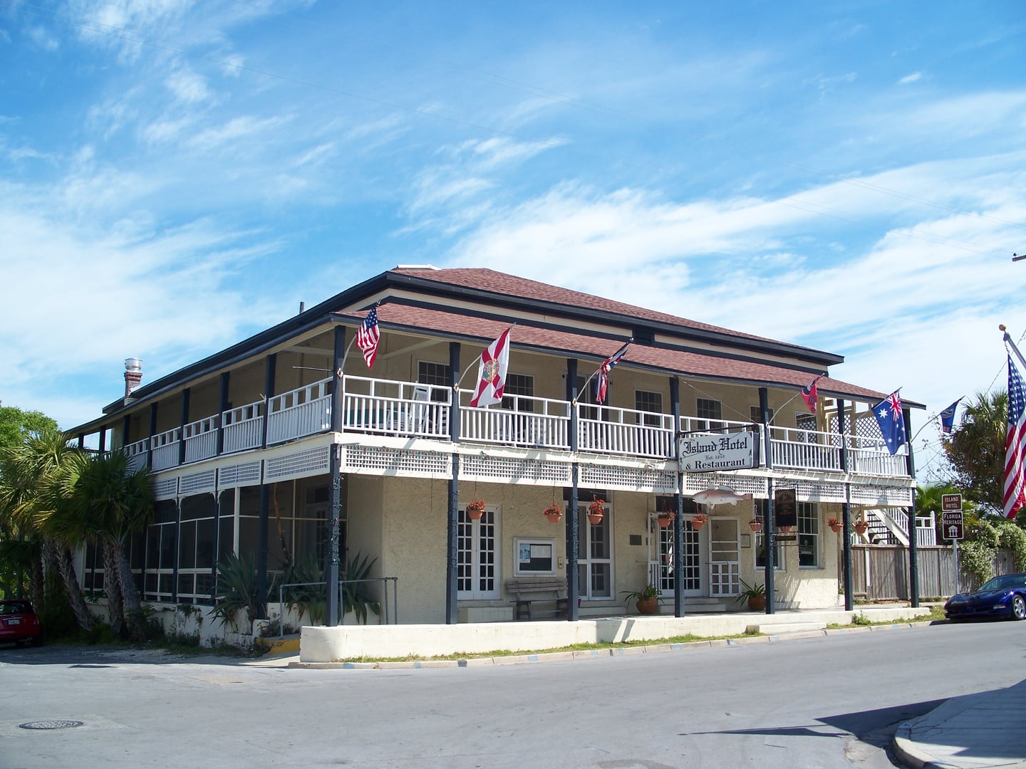Exterior of the Island Hotel in Cedar Key Florida, a two-story tabby-walled historic building with wooden porch