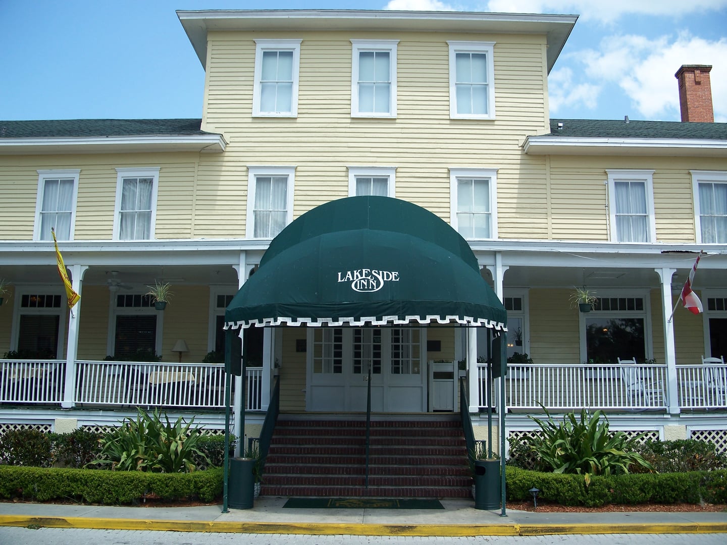 Exterior of the Lakeside Inn in Mount Dora, Florida, showing the historic white clapboard hotel on the edge of Lake Dora