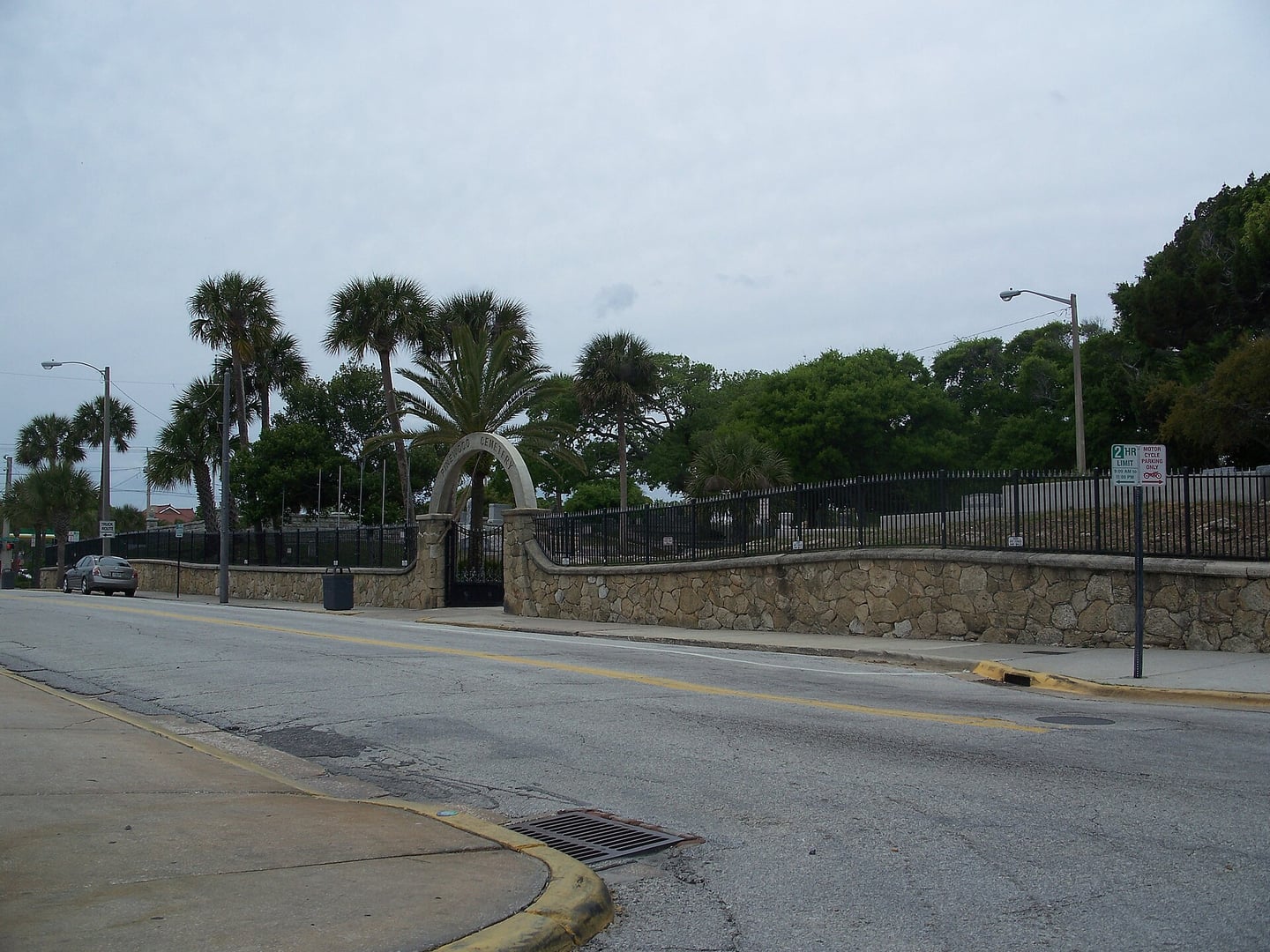 Pinewood Historic Cemetery grounds in the Daytona Beach Surfside Historic District, with historic markers and stone walls visible