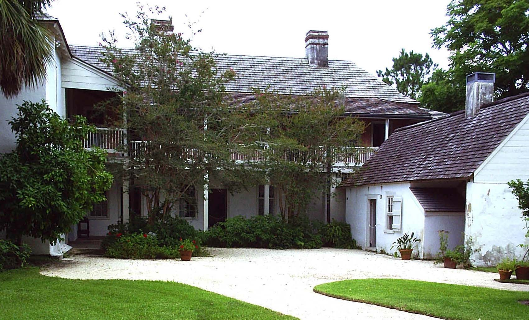 Exterior of the Ximenez-Fatio House Museum at 20 Aviles Street, St. Augustine — an 1798 Spanish colonial coquina building with distinctive balconies