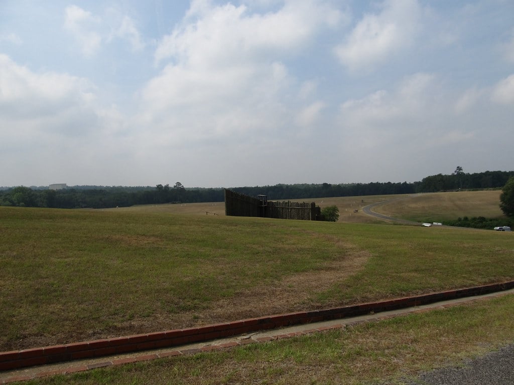Reconstructed stockade walls at Andersonville National Historic Site with the Providence Spring marker visible