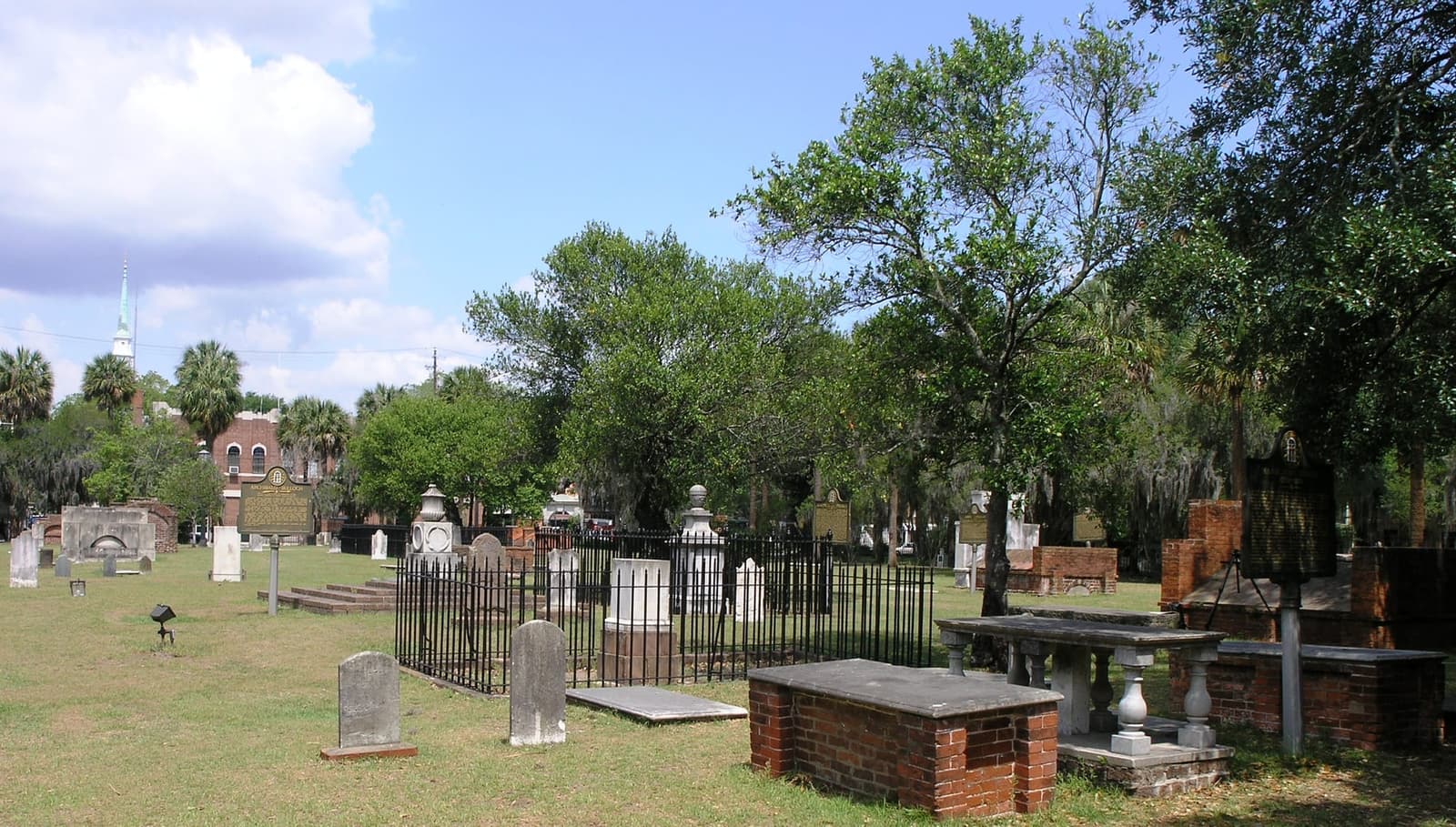 Colonial Park Cemetery in Savannah Georgia, looking west toward Abercorn Street with weathered colonial gravestones