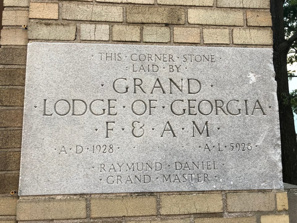 The building's cornerstone, inscribed "Grand Lodge of Georgia F&AM, A.D. 1928," from the theatre's original construction as the Yaarab Shrine Temple.