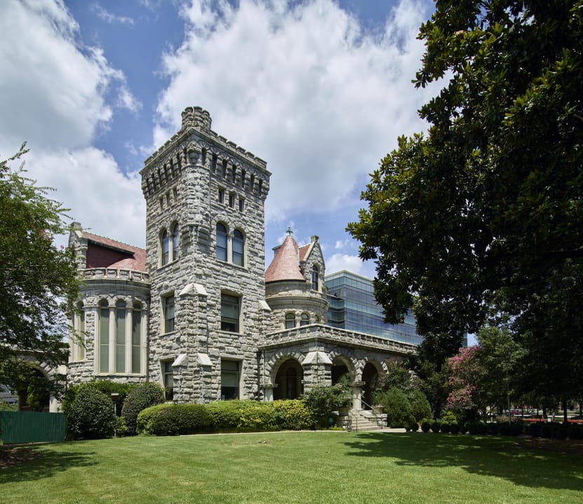 Professional exterior photograph of Rhodes Hall (the "Castle on Peachtree") by Carol M. Highsmith, full lush-green-season view of the facade and tower.