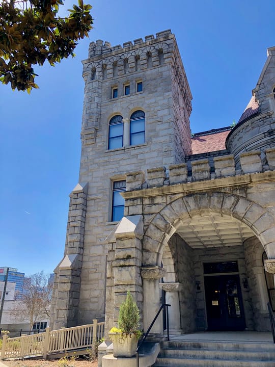 Rhodes Hall's square crenellated tower and arched main entrance seen from the front steps, Atlanta, March 2019.
