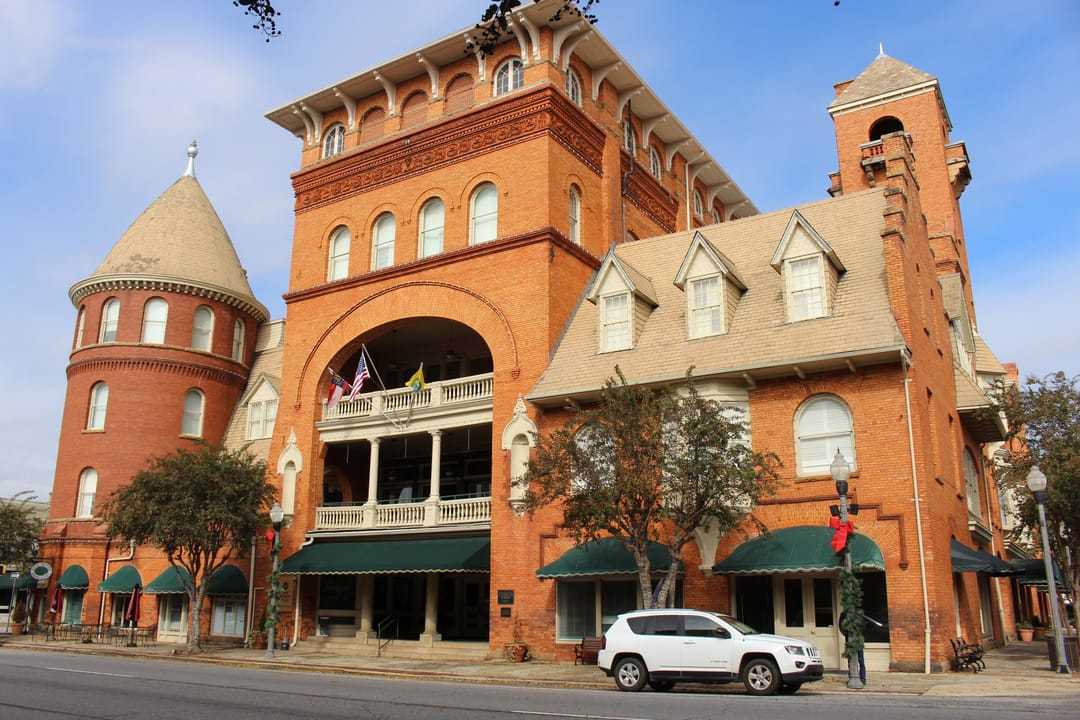 The Windsor Hotel viewed from the southeast, showing its turret and arcaded porches, Americus, Georgia.