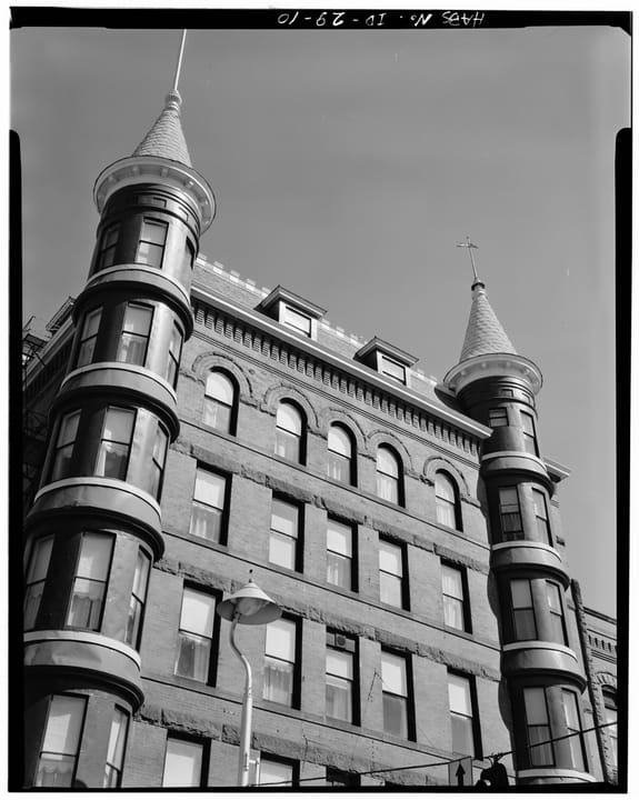 Historic American Buildings Survey black-and-white architectural photograph of the Idanha Hotel's corner turrets and upper stories, taken from street level looking up, part of the Library of Congress HABS ID,1-BOISE,13 survey set.