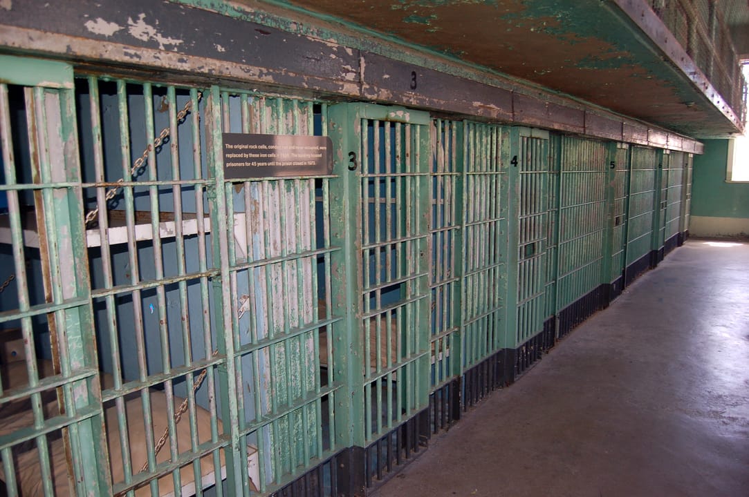 The sandstone Administration Building at the Old Idaho State Penitentiary, Boise, Idaho, with 'IDAHO STATE PENITENTIARY' lettered over the entrance.