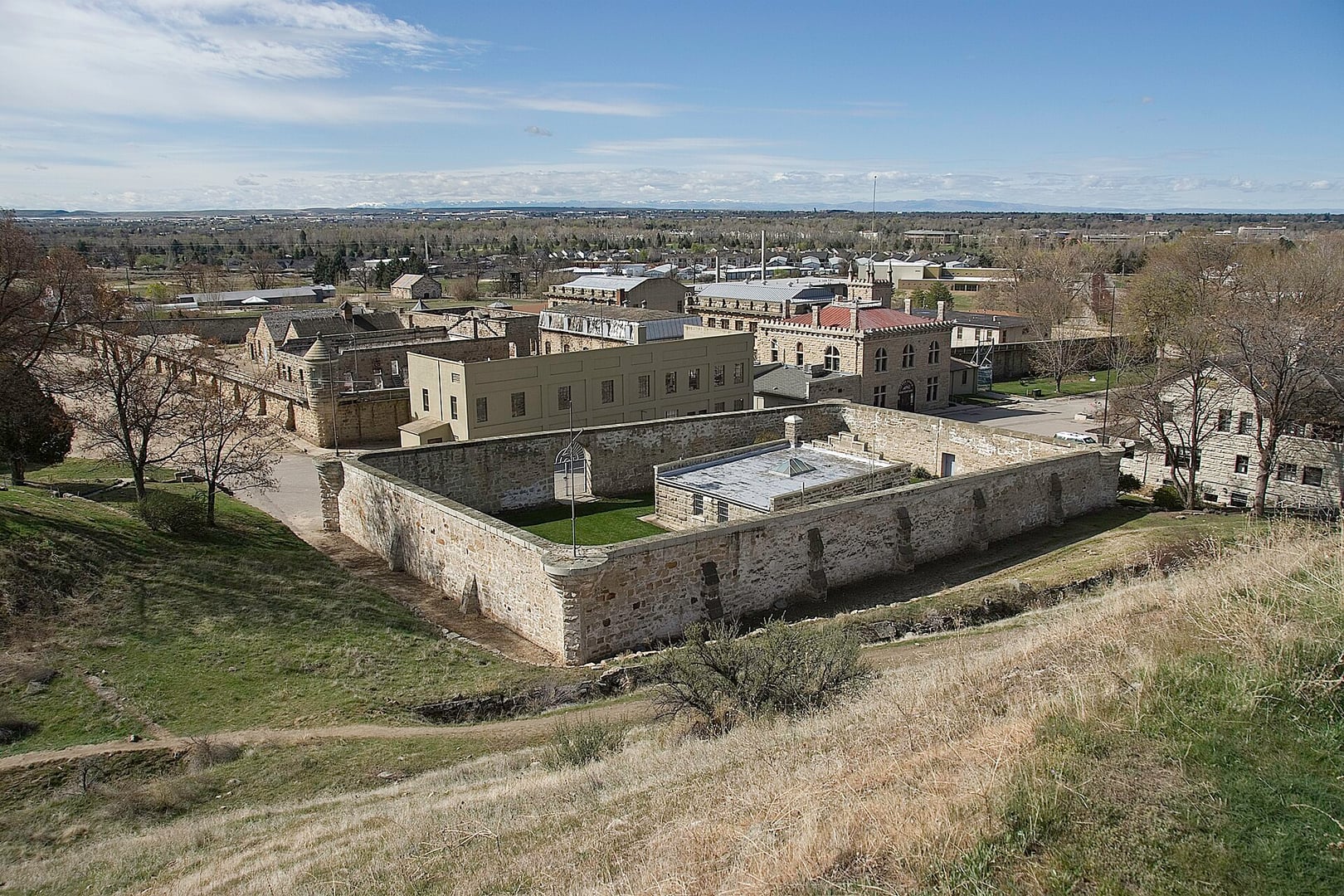 Overview of the Old Idaho State Penitentiary in Boise, Idaho, showing the sandstone cell blocks and grounds of the 1872 territorial prison complex