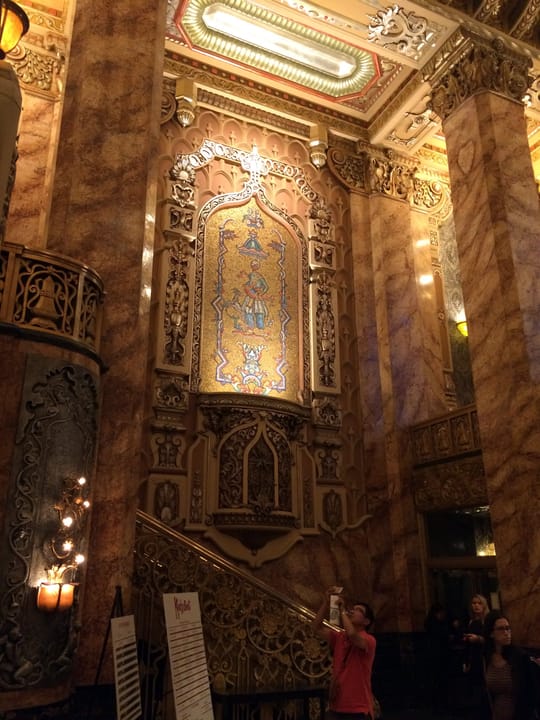 Interior view of an ornate gilded wall niche and marble pillars in the theater's lobby (the theater opened in 1926 as the Oriental Theatre, now the James M. Nederlander Theatre).