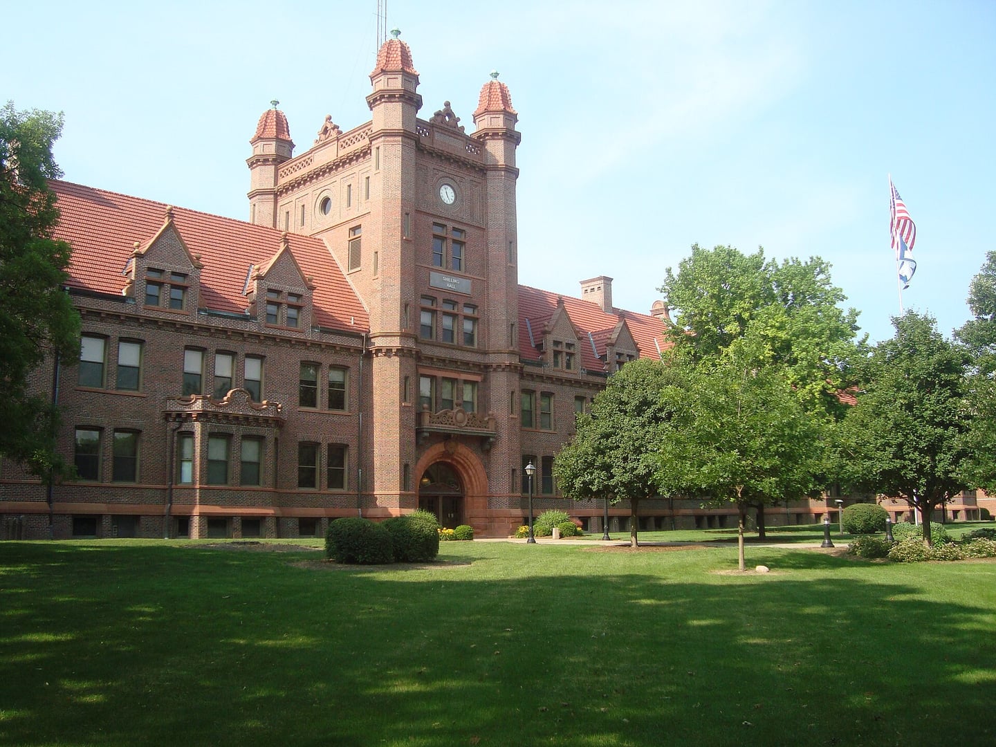 Exterior of Schilling Hall at Millikin University in Decatur, Illinois, a red brick Romanesque Revival building housing the Albert Taylor Theater