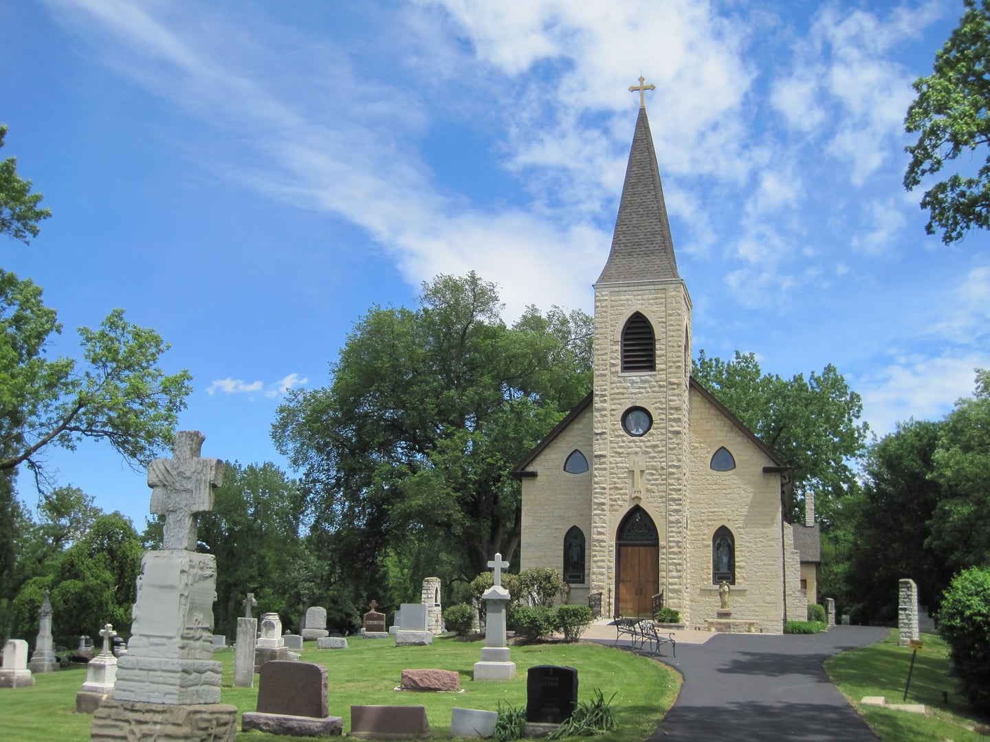 The limestone St. James at Sag Bridge Catholic Church atop its hilltop cemetery overlooking the Calumet Sag Channel near Lemont, Illinois.