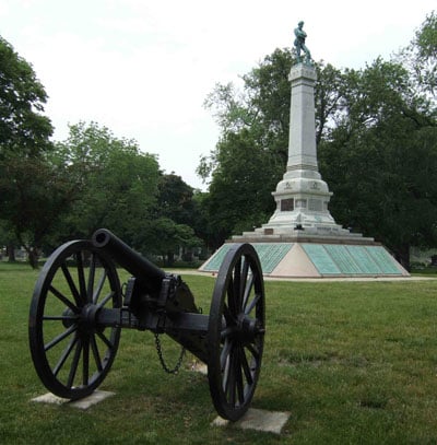 The Confederate Mound monument at Oak Woods Cemetery in Chicago, a granite column topped with a bronze soldier marking the mass grave of Civil War prisoners