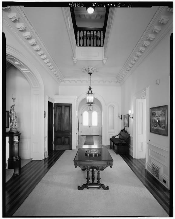 The main hall and east vestibule inside Quarters One, with its original woodwork, Rock Island Arsenal, HABS 1985 -- a room shown on the house's public tours.
