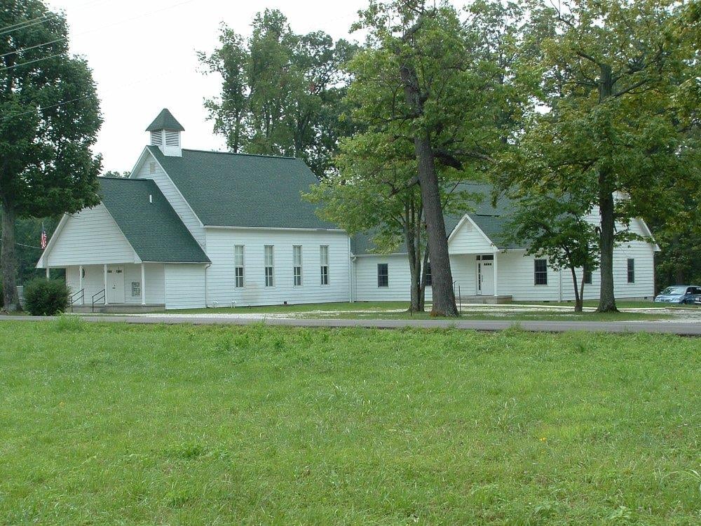 Bonds Chapel United Methodist Church exterior, a white wood-frame country church with green roof and cupola in Orange County, Indiana, home of the famous chain tombstone cemetery