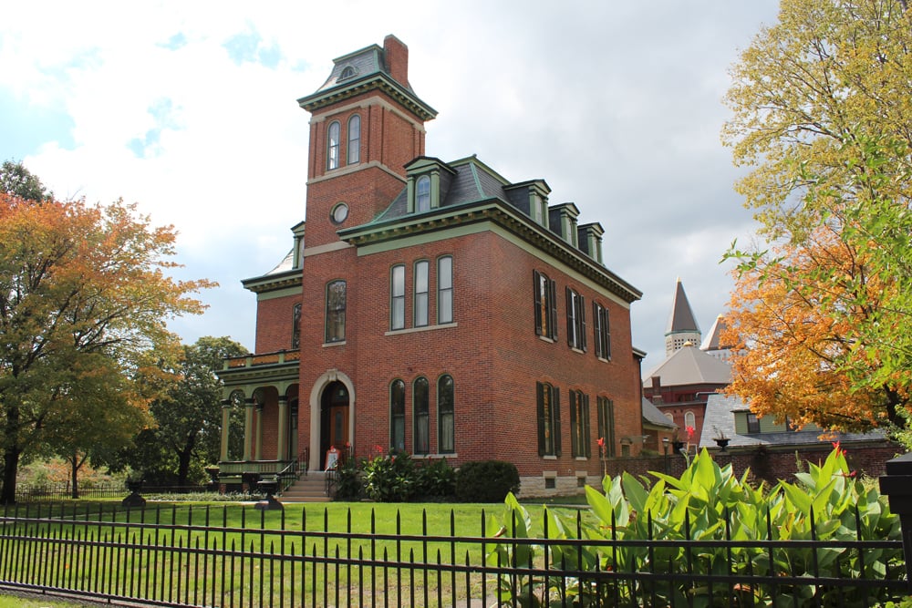 Exterior of the Morris-Butler House Second Empire mansion with mansard roof, tower, and veranda at 1204 North Park Avenue in Indianapolis, Indiana