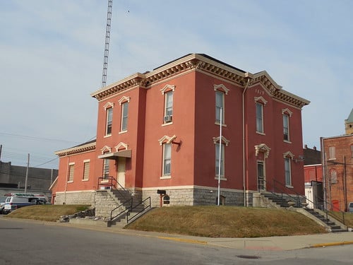 The brick exterior of the Old Blackford County Jail in Hartford City with its sheriff's-residence facade and cellblock at the rear