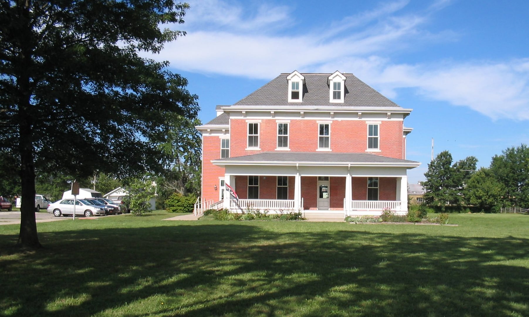 Exterior of the Scott County Heritage Center and Museum, the 1892 former county poor farm brick building at 1050 S Main Street in Scottsburg, Indiana