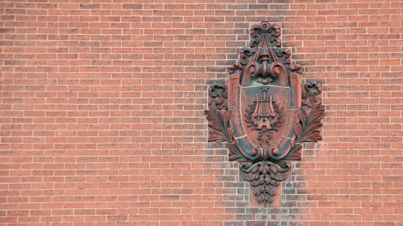 Carved relief sculpture set into the exterior brick wall of the Rathskeller, the Athenaeum's historic German beer hall, Indianapolis.