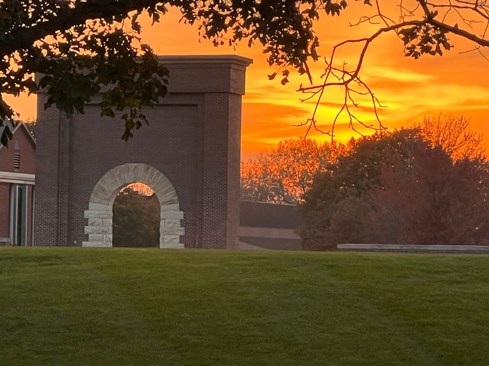 The brick Victory Arch at the entrance to Buena Vista University's campus in Storm Lake, Iowa, at sunset, October 2022.