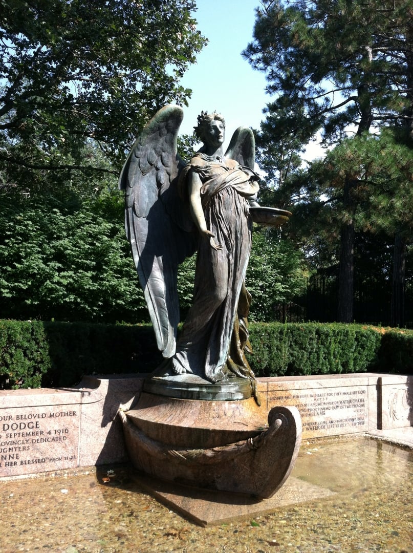 The dark bronze Black Angel statue of the Ruth Anne Dodge Memorial at the entrance to Fairview Cemetery in Council Bluffs, Iowa