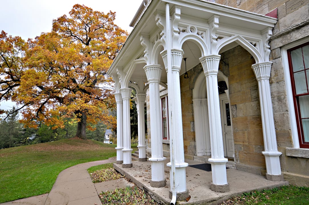A close view of the Mathias Ham House's Gothic-arched porch columns and stonework, Dubuque, Iowa.