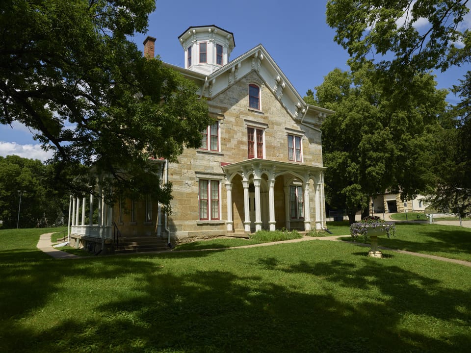 The Mathias Ham House's symmetric front facade with its octagonal cupola and columned entrance porch, summer, Dubuque, Iowa.