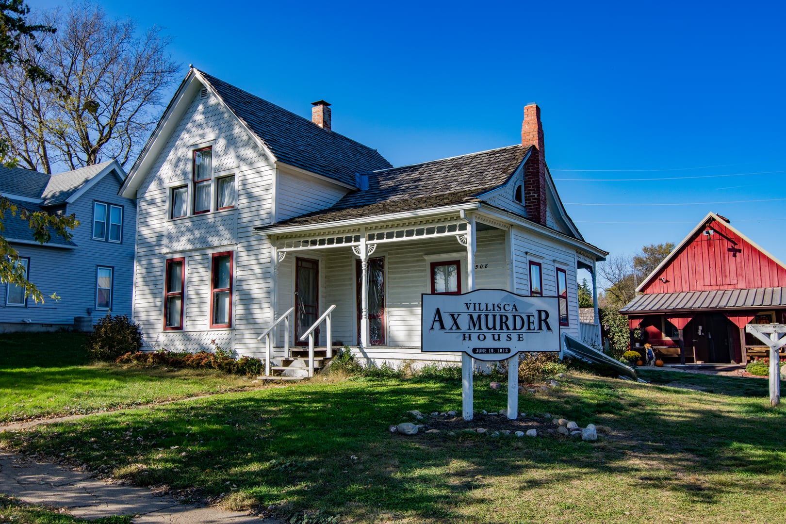 White wood-frame farmhouse at 508 E 2nd Street in Villisca, Iowa under overcast sky