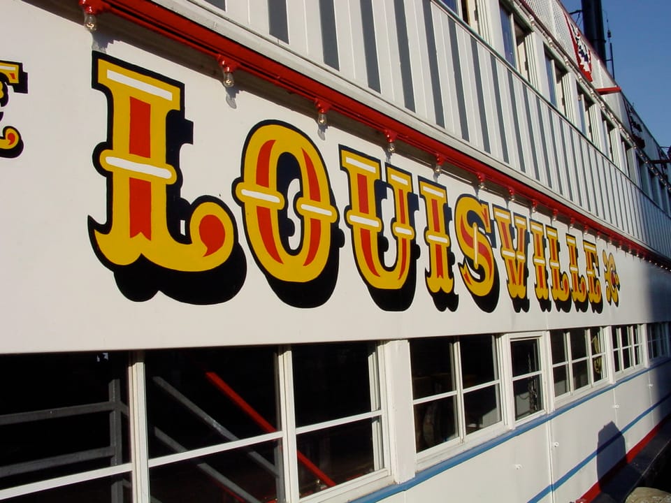 Detail of the hand-painted 'Louisville' lettering along the hull of the Belle of Louisville.