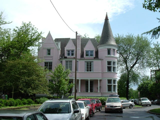 Pink Victorian mansion with French chateau turret at the south end of St. James Court in Old Louisville