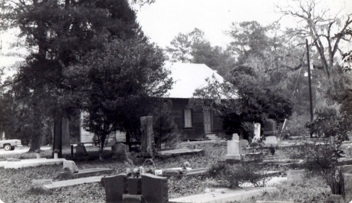 Historic Big Woods Cemetery in Edgerly, Louisiana, with massive oak canopy and grave markers
