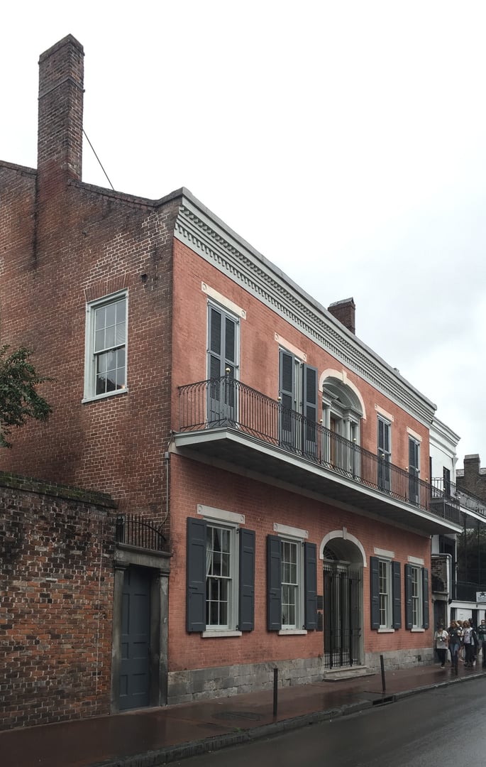 American Federal-style brick facade of the Hermann-Grima House (1831) at 820 St. Louis Street in the New Orleans French Quarter.