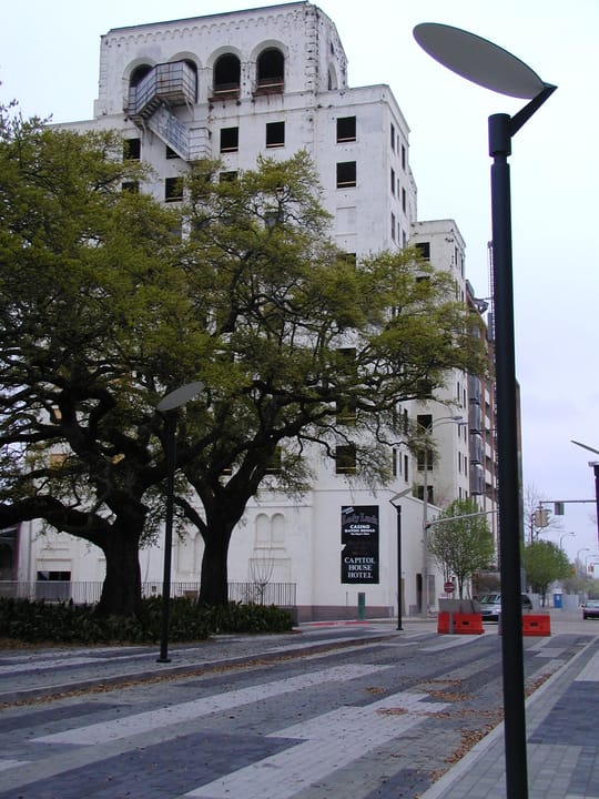 The hotel lit at dusk above the Mississippi River levee in downtown Baton Rouge, Louisiana.