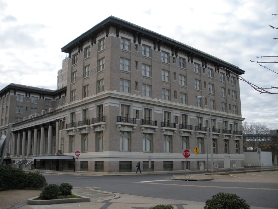 The Hotel Bentley seen from across the empty intersection at its corner, showing the full seven-story mass of the building, December 2009.