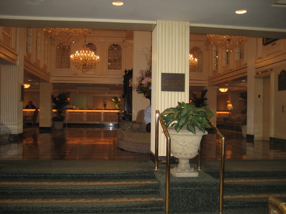 Lobby of the Hotel Monteleone, New Orleans, with chandeliers and marble columns.