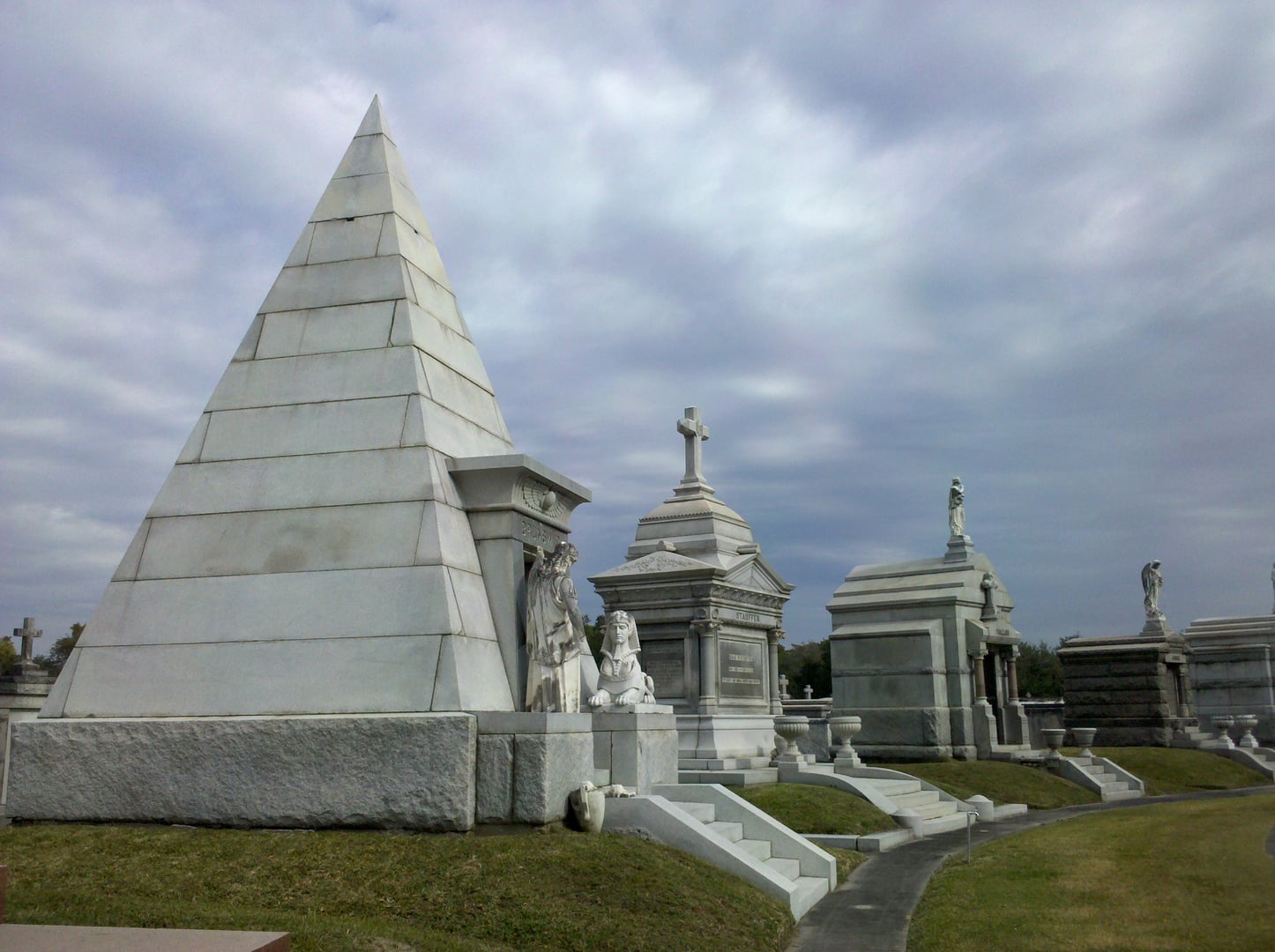 The Egyptian-style Brunswig pyramid mausoleum stands among elaborate tombs in Metairie Cemetery in New Orleans