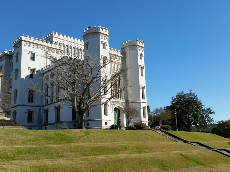 Castle-like Gothic Revival exterior of Louisiana's Old State Capitol with crenellated towers above the Mississippi River bluff in Baton Rouge