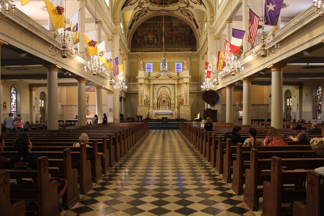 Three-spire facade of St. Louis Cathedral facing Jackson Square in the New Orleans French Quarter, America's oldest continuously active Catholic cathedral