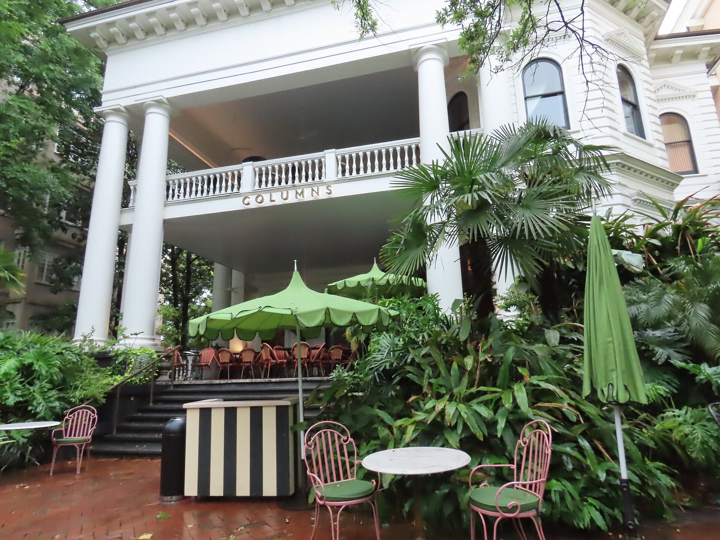 Italianate facade and white columned porch of The Columns Hotel, an 1883 mansion on St. Charles Avenue in Uptown New Orleans