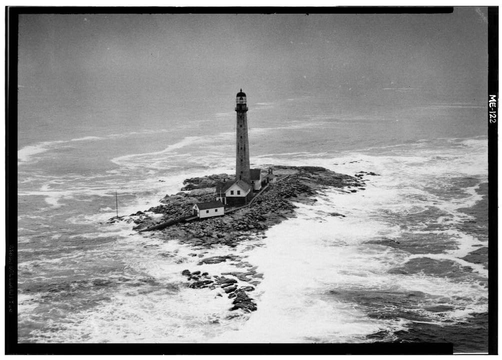 Hand-tinted postcard "Boone Island Light, York, Me." showing the light station complex with the keeper's dwellings and red roofs