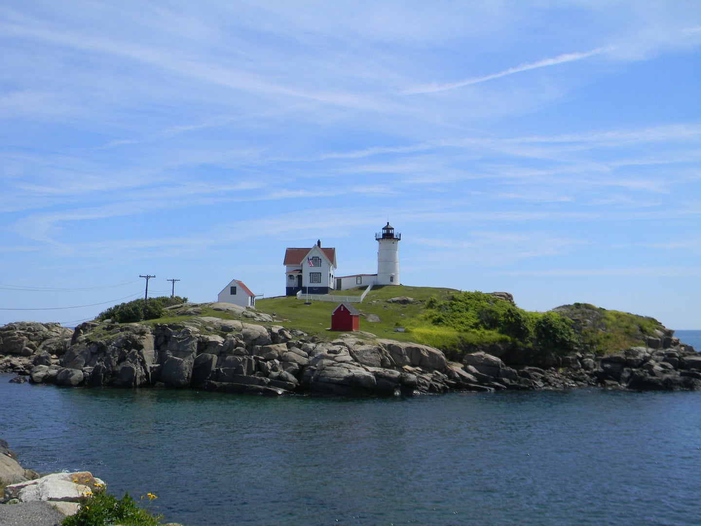 Cape Neddick Nubble Light on its small tidal island off York Beach, Maine, as seen from Sohier Park