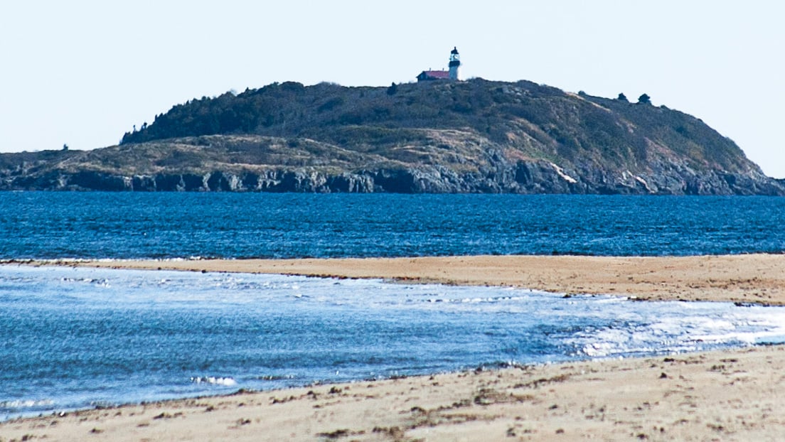 Seguin Island Lighthouse granite tower and keeper's house overlooking the Maine coast at the mouth of the Kennebec River