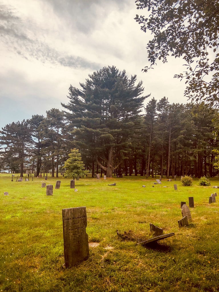 Damaged 19th-century tomb doors and slate markers at Western Cemetery beside the Western Promenade in Portland, Maine