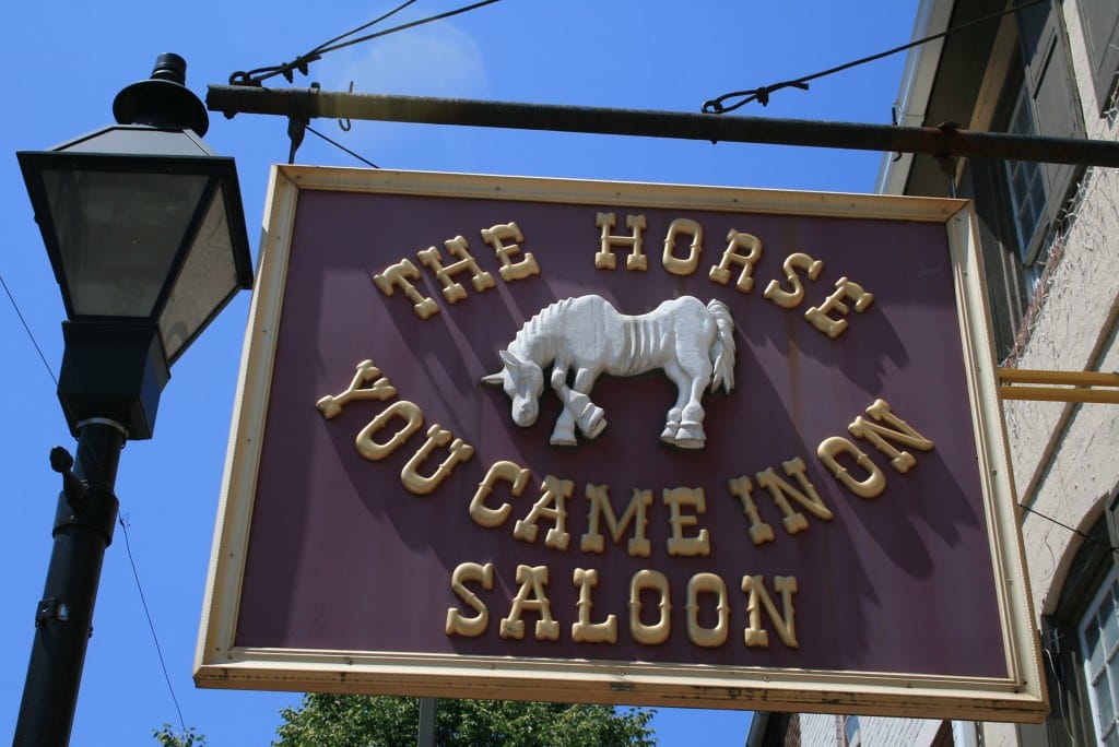 Exterior of The Horse You Came In On Saloon, 1626 Thames Street, Fells Point, Baltimore, showing the hanging sign over the entrance; photographed 2025.