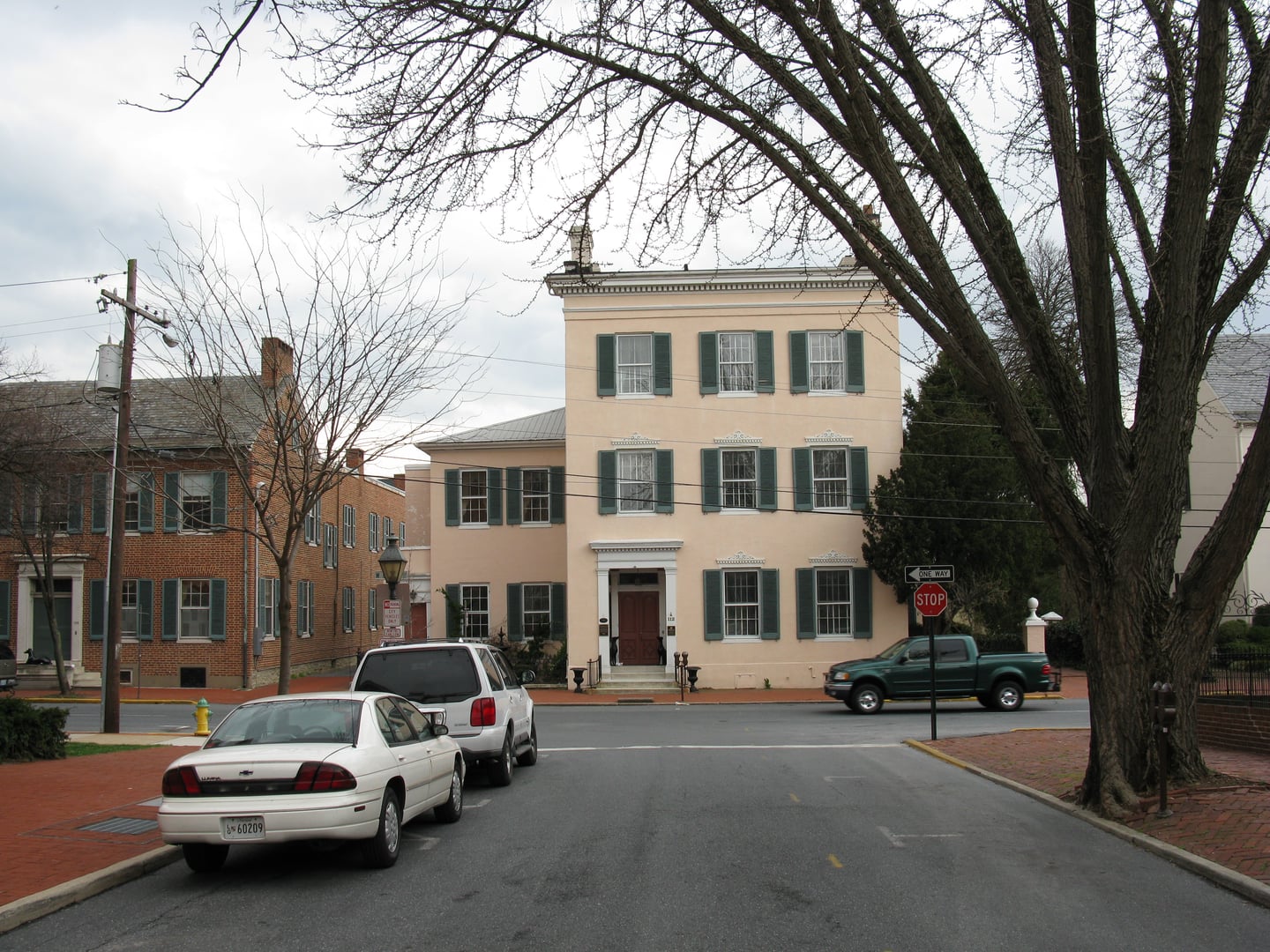 Three-story brick facade of the 1814 Tyler Spite House at 112 West Church Street, opposite Record Street in downtown Frederick, Maryland.