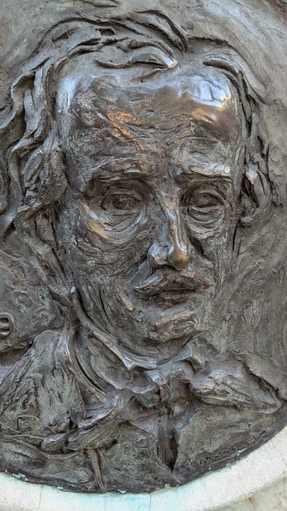 Close-up of the bronze bas-relief portrait of Edgar Allan Poe set into his monument at Westminster Burying Ground