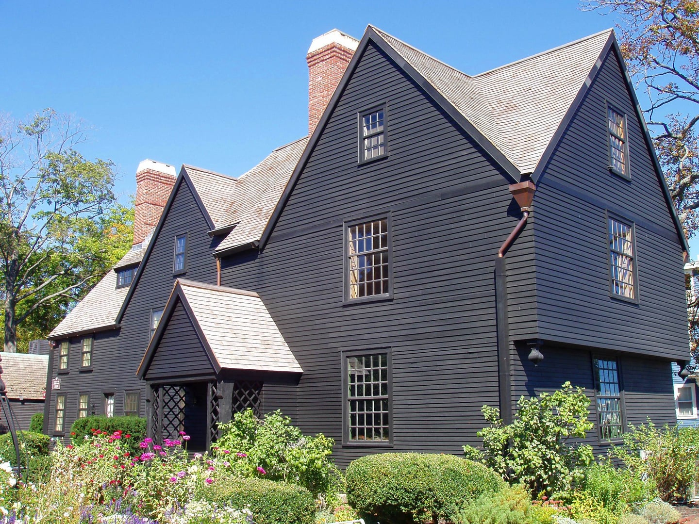 The dark-shingled gabled facade of the historic House of the Seven Gables in Salem, Massachusetts