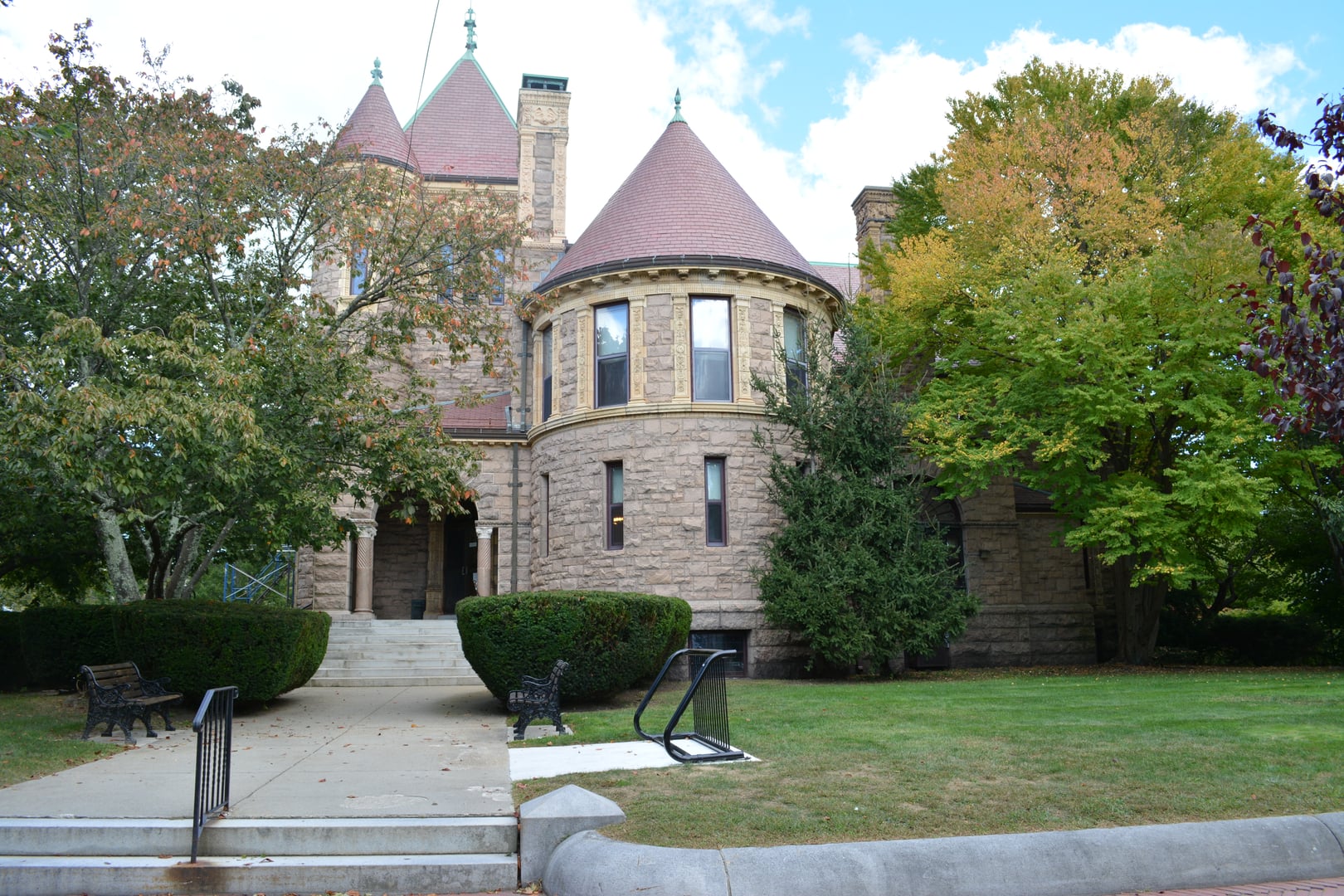 Front view of the 1892 Italian Renaissance stone facade of the Millicent Library at 45 Center Street in Fairhaven, Massachusetts.