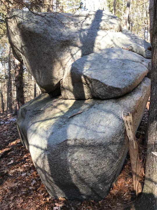 A stacked glacial boulder along a wooded trail at Dogtown, Cape Ann -- one of the many erratic boulders that give the site its character (distinct from the hero's inscribed 'COURAGE' boulder).