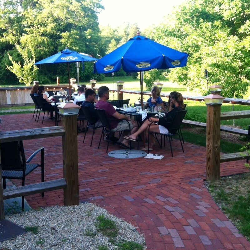 Outdoor dining patio at The Sun Tavern, a 1741 pre-Revolutionary farmhouse restaurant in Duxbury, Massachusetts.